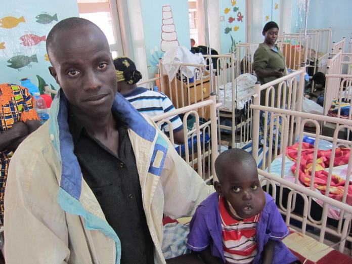 Most Ugandan families, such as this one seen at the Uganda Cancer Institute (UCI), are too poor to afford proper treatment for the deadly disease.