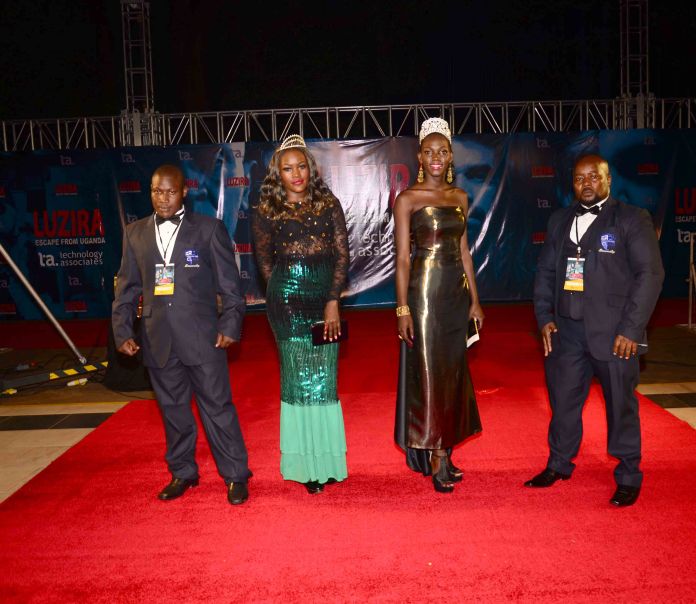 Reigning Miss Uganda Leah Kalanguka (2nd R) and her predecessor Phiona Bizzu arriving for the premiere last Friday.