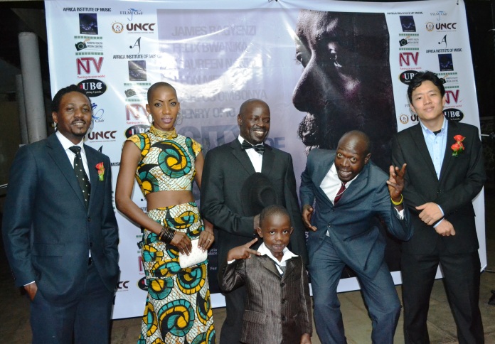 (L-R) James Bagyenzi, Maureen Jolly Nankya, Carlos Ombonya, Felix Bwanika and Young Kim posing with Ombonya's son on the red carpet at the premiere.