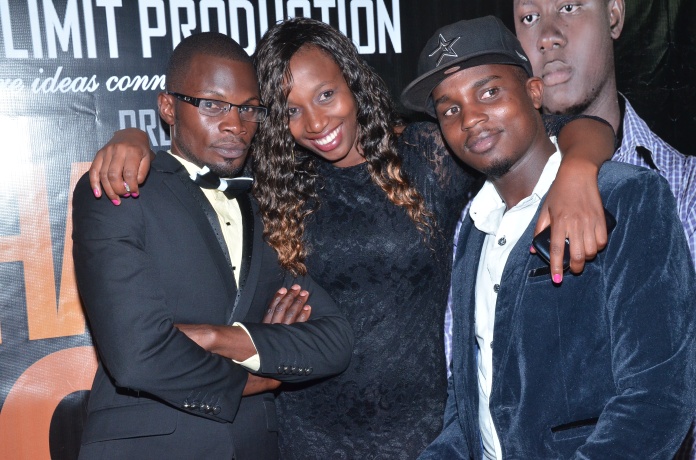 The film's writer and director, Richard Mulindwa (L) posing for a photo with fans at the red carpet.